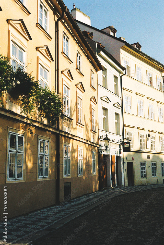 Obraz premium typical Prague cityscape. You can see Prague house facades and the Charles Bridge, also you can feel the Prague old town flair.