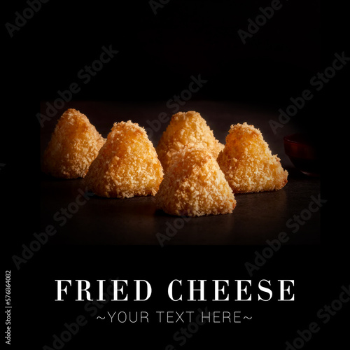 Side view of fried cheese dish isolated on black background. Ready advertising banner with text and copy space image.