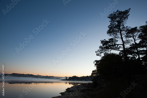 sunrise over the lake with mist. © JG Marshall