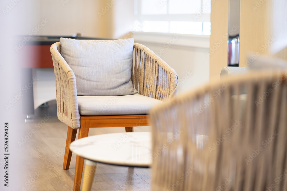 A minimalist gray soft chair in a space to relax on a casual day A minimalist gray soft chair in a space to relax on a casual day