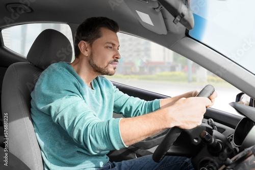 Sleepy tired man driving his modern car