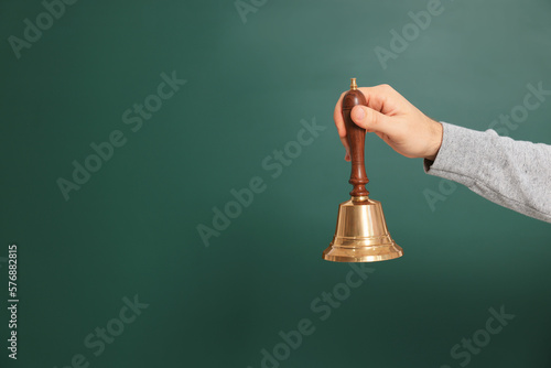 Foto Teacher with school bell near chalkboard, closeup. Space for text
