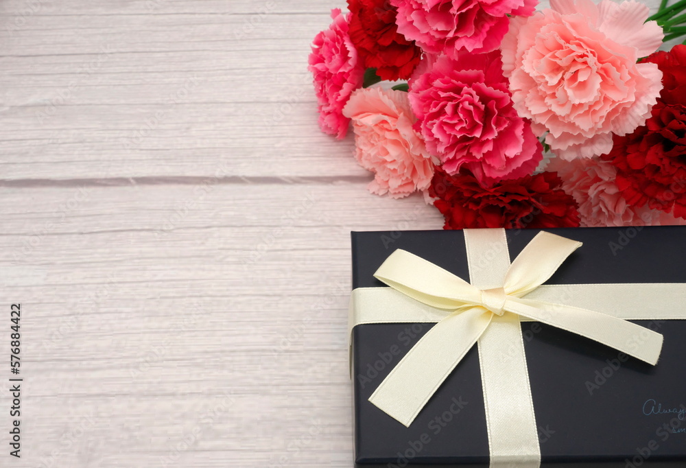 Mother's Day carnations and gifts (wood grain background) Mother's Day carnations and gifts (wood grain background)