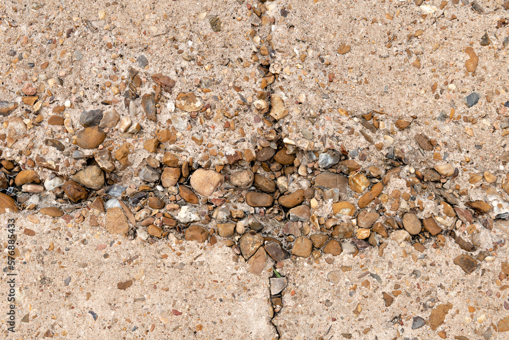 Eroded concrete with aggregate exposed on the sea wall in Galveston