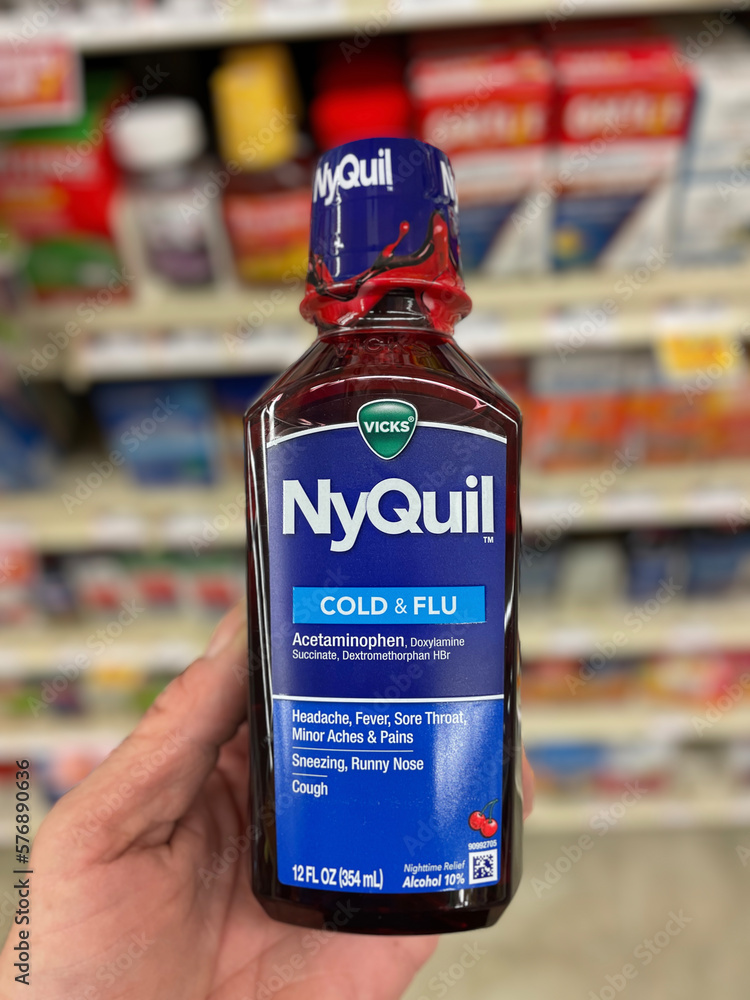 Grocery store hand holding Grocery store NyQuil cold and flu medicine ...