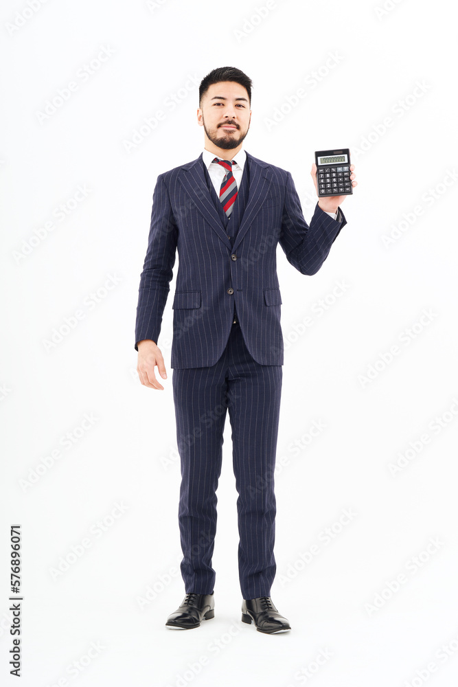 A man in a suit with a calculator A man in a suit with a calculator