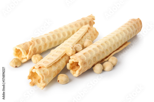 Delicious wafer rolls and hazelnuts isolated on white background