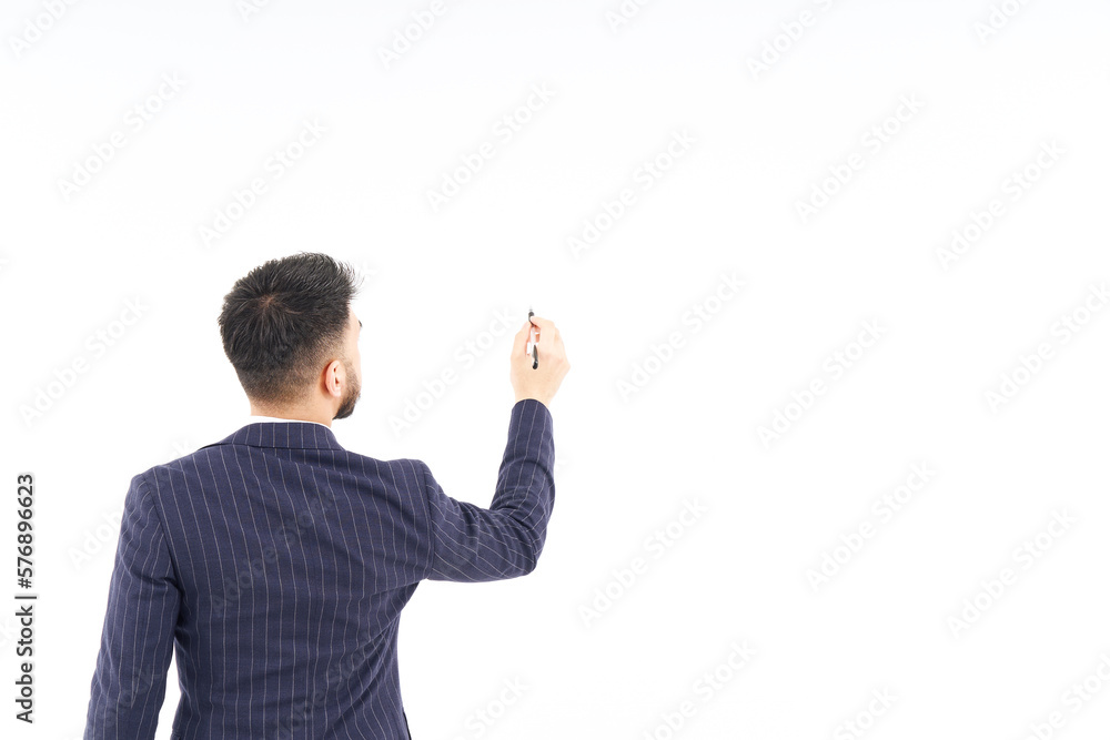 A man in a suit posing to write with a pen A man in a suit posing to write with a pen