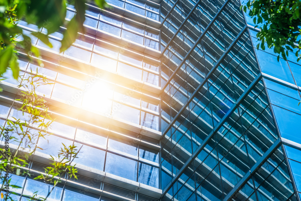 modern office building with green leaves. modern office building with green leaves.