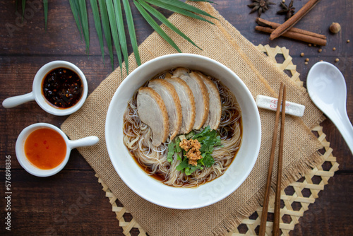 Duck Noodles soup - Braised of duck noodles in white bowl of wood table at top view, Asian food