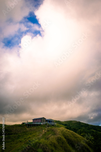 A wooden hut on top of a hill during sunrise. Portrait. Cabaliwan Peak, Romblon, Philippines