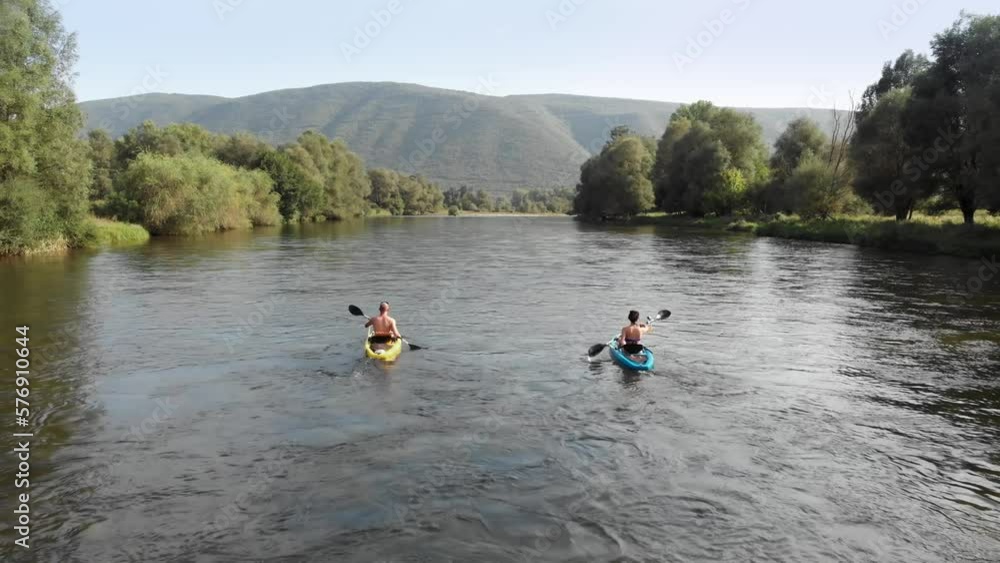 Drone video following two people kayak Nestos river Greece sunny day summer Drone video following two people kayak Nestos river Greece sunny day summer
