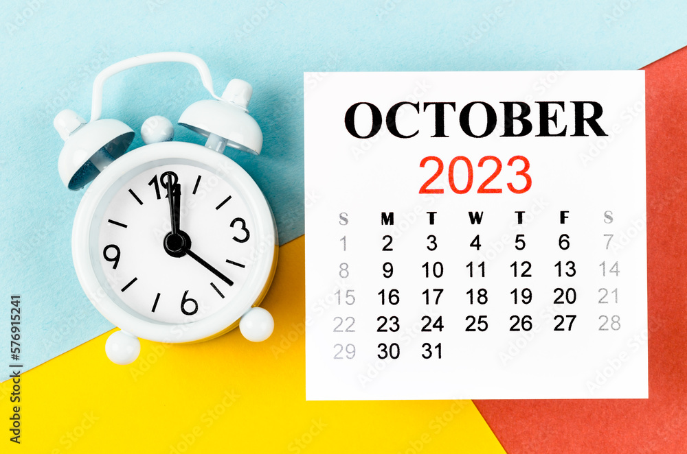 The October 2023 Monthly calendar year with alarm clock on colourful background. The October 2023 Monthly calendar year with alarm clock on colourful background.