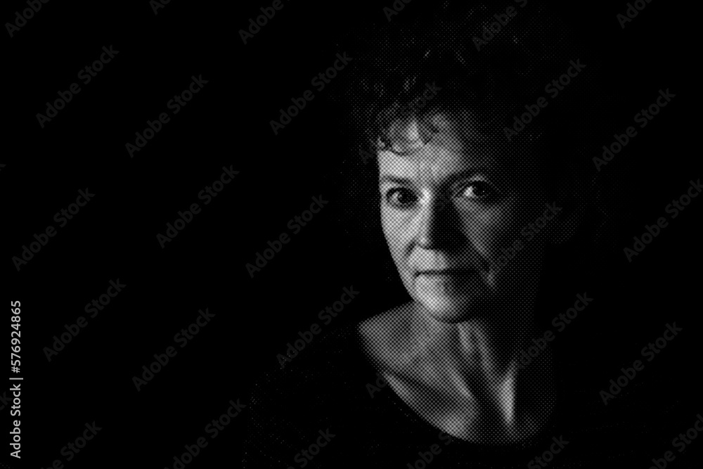 Black and white textured portrait of a middle aged woman with a neutral expression.  Low key background, room for copy.