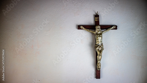 a cross hung on a white wall