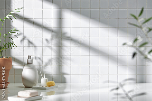 Various objects on a white tile background with warm sunlight shining through
