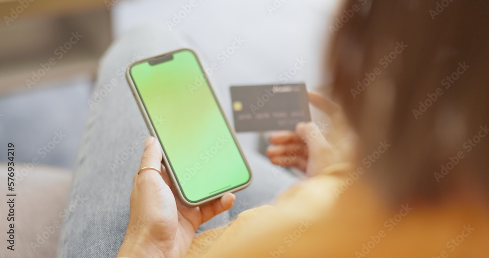 Top view, smartphone and woman with credit card, green screen and online payment in living room. Female, lady and cellphone for transactions, mockup and customer with budget, finance and banking app Top view, smartphone and woman with credit card, green screen and online payment in living room. Female, lady and cellphone for transactions, mockup and customer with budget, finance and banking app