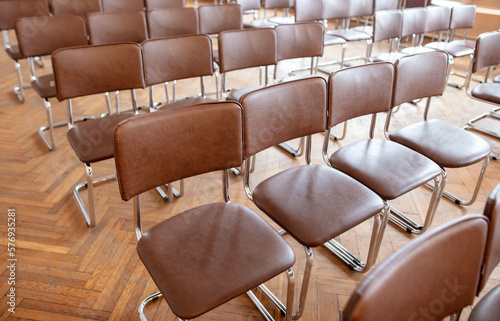 Brown chairs in the auditorium as background