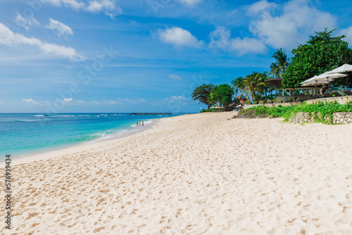 Tropical beach in Bali island. Scenic coastline with coconut palms.