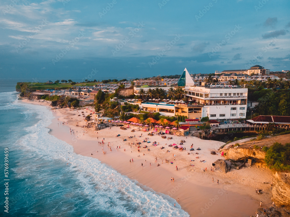 Tropical beach with ocean. Dreamland beach with sunset tones in Bali. Aerial view