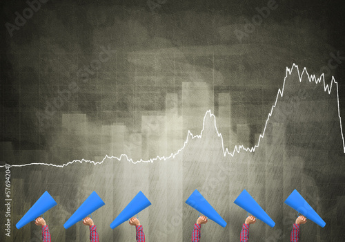 female hands in a row holding blue paper trumpets against graphs background