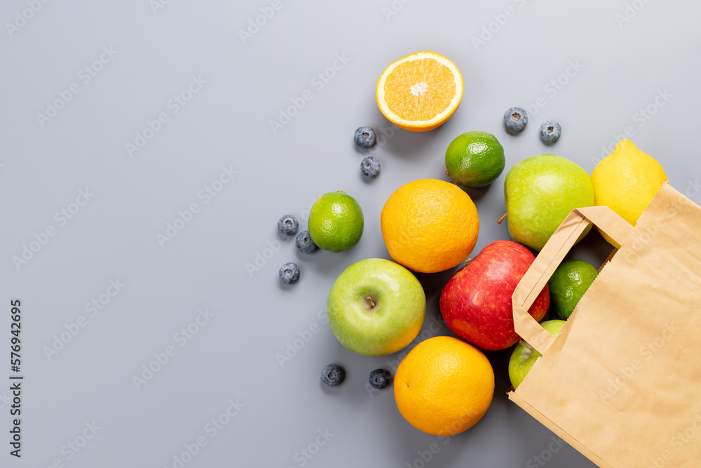 Shopping paper bag full of healthy food on grey Shopping paper bag full of healthy food on grey