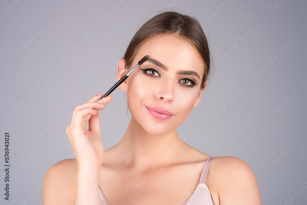 Eyebrow makeup. Beauty model shaping brows with brow pencil closeup. Womans eyebrows with eyebrow brush. Natural make up. Modeling brows. Comb eyebrows. Eyebrow makeup. Beauty model shaping brows with brow pencil closeup. Womans eyebrows with eyebrow brush. Natural make up. Modeling brows. Comb eyebrows.