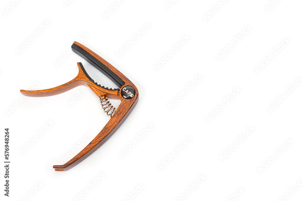 Metal capo for guitar with spring painted wood. Metal capo for guitar with spring painted wood.
