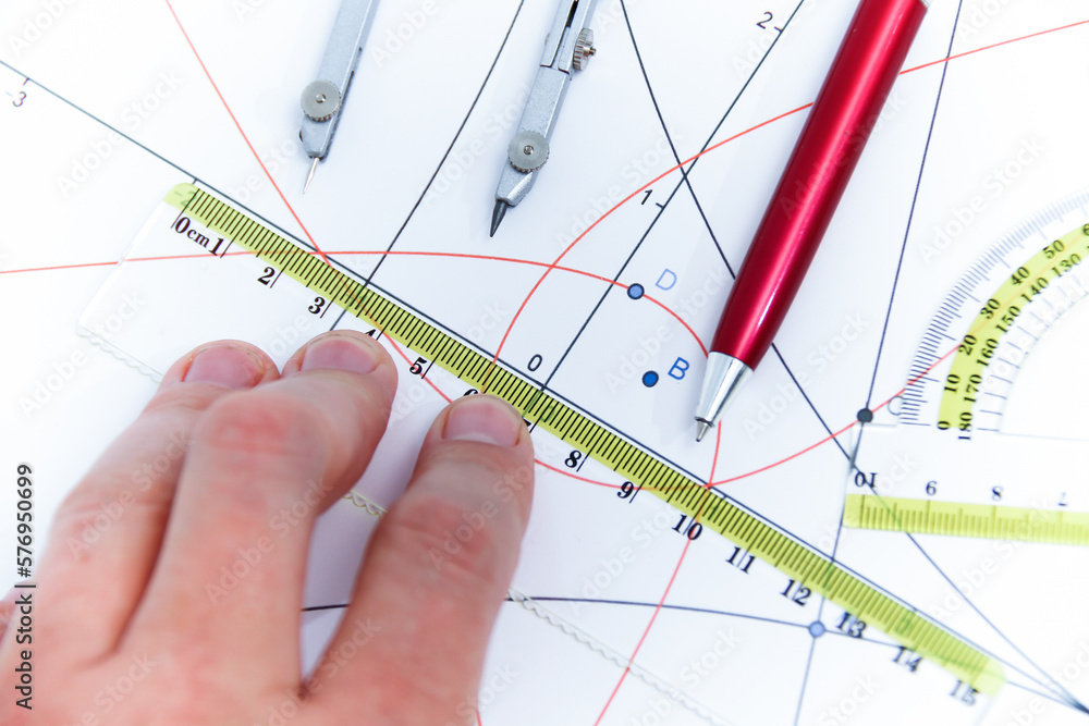 Professional architect working at his desk, measuring and estimating the building project Professional architect working at his desk, measuring and estimating the building project