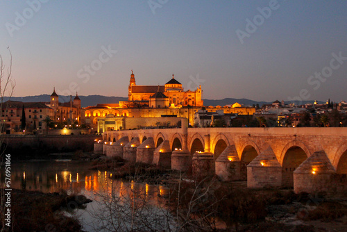 sunset view over the beautiful mezquita of Cordoba with a bridge and river in front