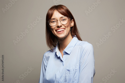 Funny Smiling Happy Girl in glasses. Beautiful laughing Woman