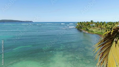 From the cococnut tree branches viewing the beach landscape. photo