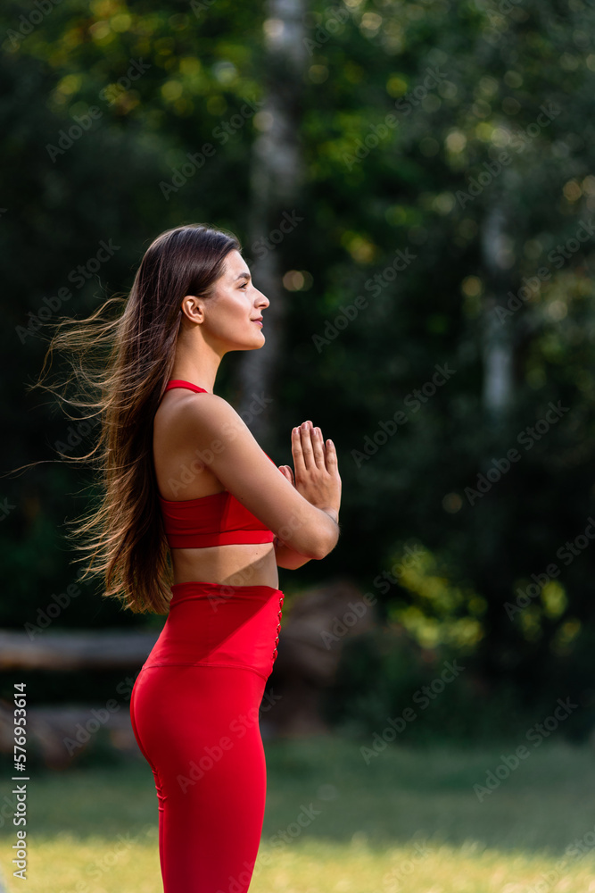 Portrait of young slim athletic woman in sporty outfit relaxing and meditating in park Portrait of young slim athletic woman in sporty outfit relaxing and meditating in park