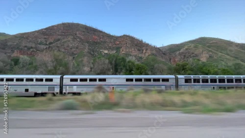 amtrak train speeds through the desert tracking shot photo