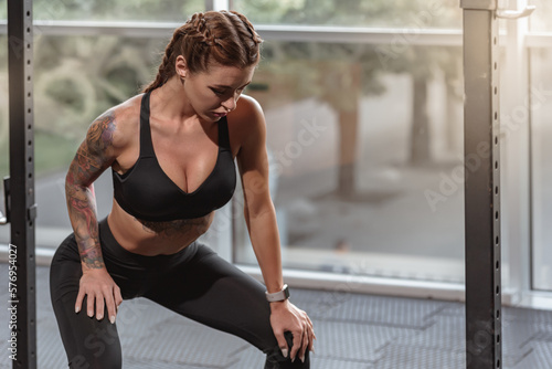 Beautiful fit slim woman in sportswear working out alone at gym