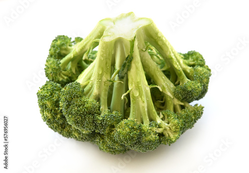 Fresh broccoli cabbage closeup, isolated on white background. Green raw vegetable, just washed florets are covered by water drops. Harvest from sunny organic garden. Diet and healthy food concept.
