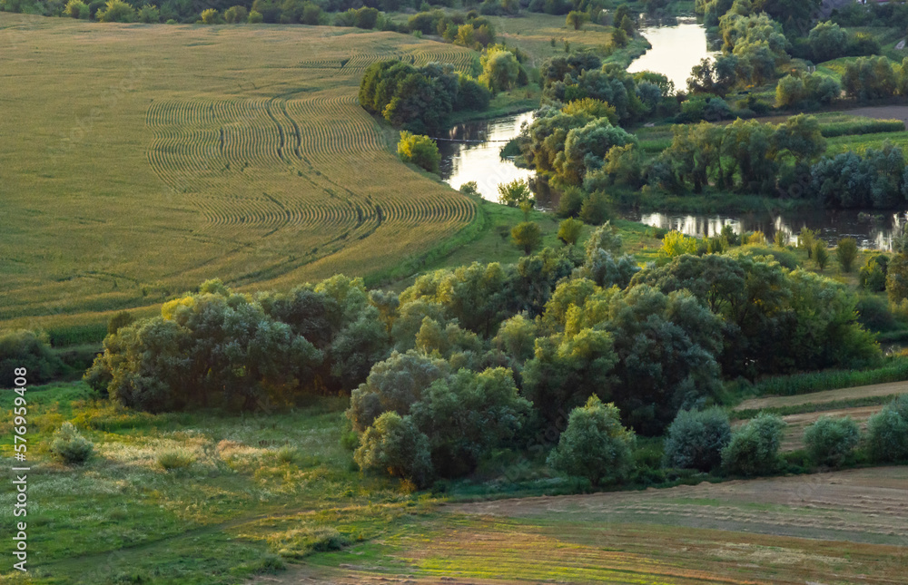 Obraz premium Sunny summer landscape with river.Green hills and meadows