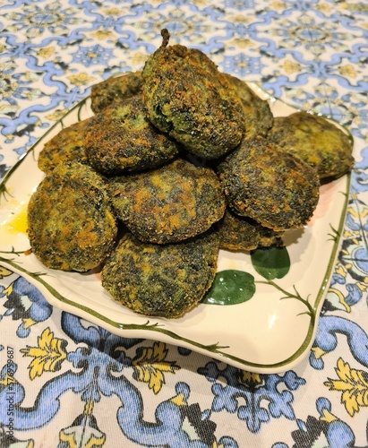 Homemade dish of spinach meatballs with egg, breadcrumbs, cheese and salt 