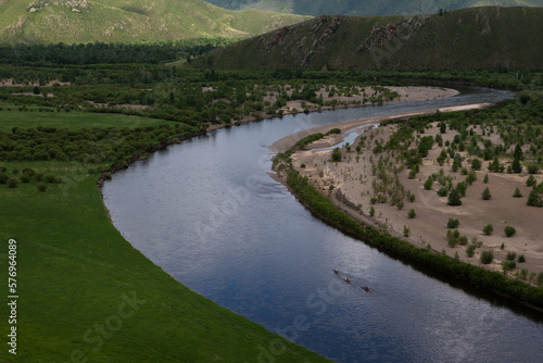 Three women paddle their kayaks on the Onon river in northen Mongolia. photo