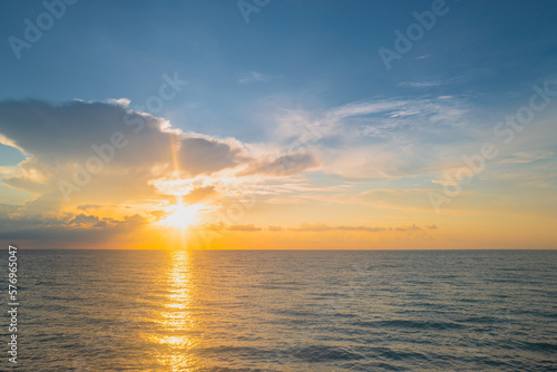 Sunset sea landscape. Colorful beach sunrise with calm waves. Nature sea sky. Sunrise with clouds of different colors against the blue sky and sea. Ocean and sky background  seascape.