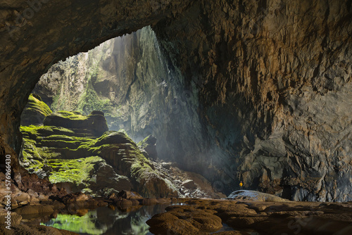 A cave explorer stands at the opening of the first doline, or skylight, in Hang Son Doong.