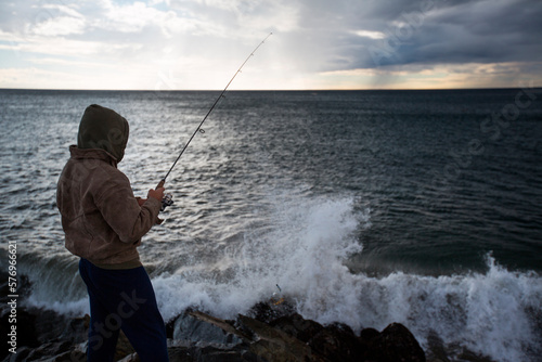 Wallpaper Mural Fisherman fishing while storm blows in Torontodigital.ca