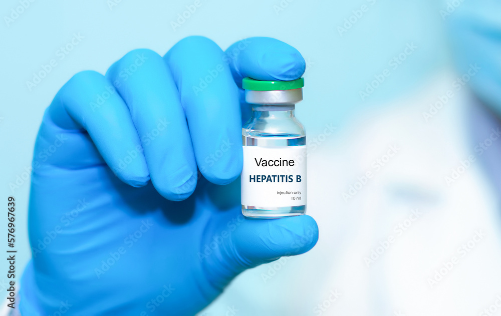Doctor in protective gloves holding a hepatitis B vaccine . The concept of medicine, healthcare, science and vaccination awareness. Doctor in protective gloves holding a hepatitis B vaccine . The concept of medicine, healthcare, science and vaccination awareness.
