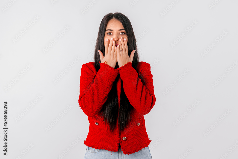Portrait of girl looking shocked after hearing something, touches her mouth and looks speechless, stands over white background Portrait of girl looking shocked after hearing something, touches her mouth and looks speechless, stands over white background