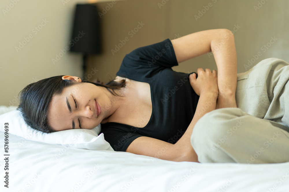 Asia woman Suffering from Stomach ache on bedroom. Asia woman Suffering from Stomach ache on bedroom.