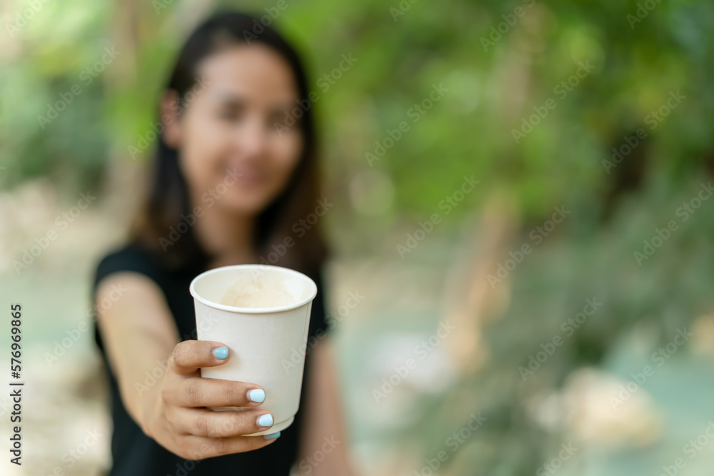 Woman hand with paper cup of coffee. Woman hand with paper cup of coffee.