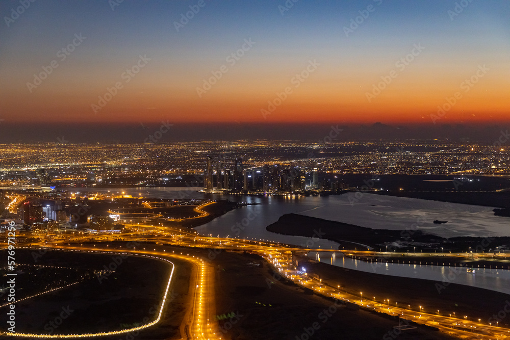 city skyline at sunrise of dubai from the burj khalifa