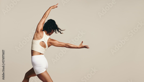 Female athlete doing stretching exercises for endurance and flexibility