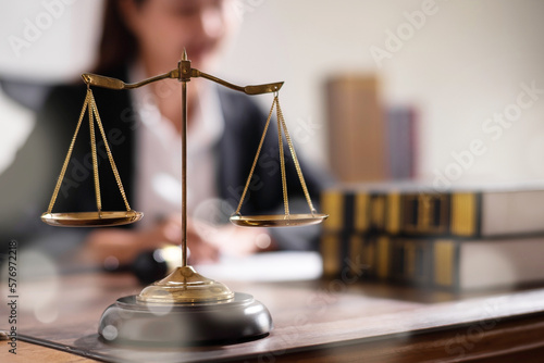 Fototapeta Scale balance of justic on judge work desk.