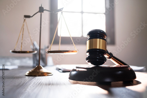 Judge hammer and scale balance on judge work desk.